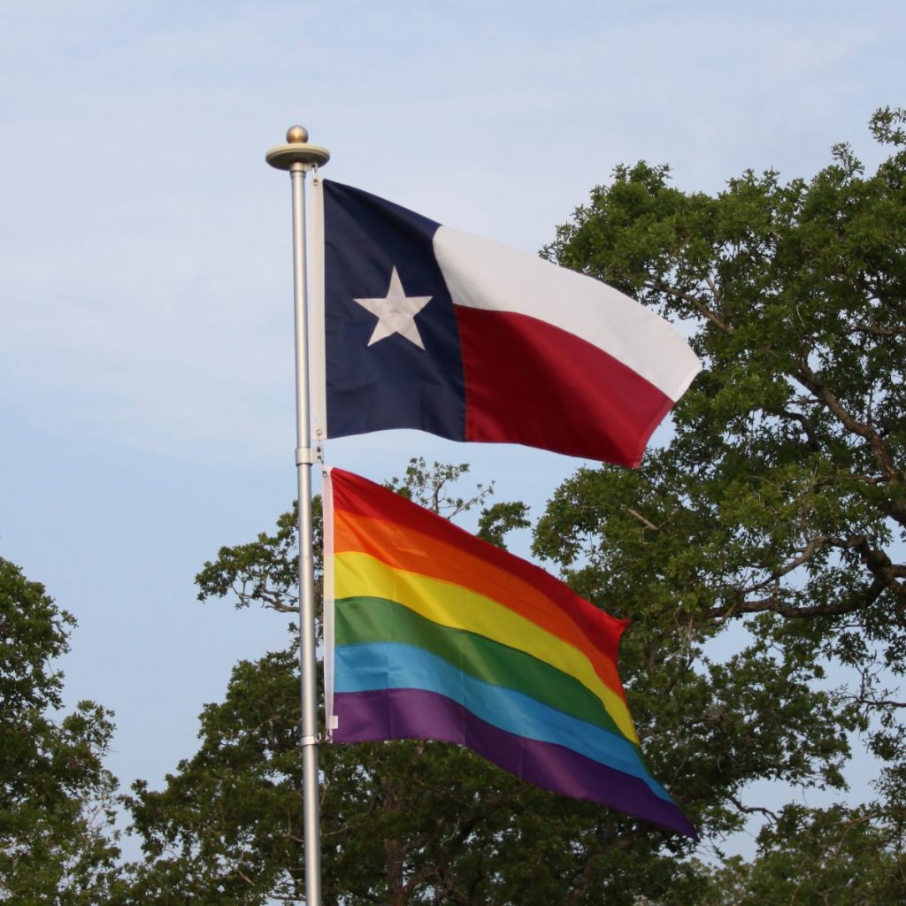 The Texas Flag and LGBT Pride Flag flying on the same flagpole